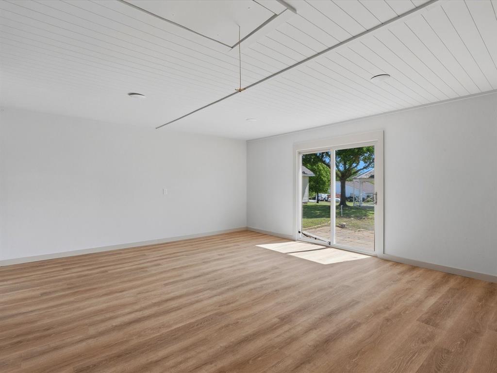 289 County Road 4655 Rhome, TX 76078 - Photo 25 of 34 Spacious interior room featuring wood-finish flooring, white walls, and a white plank ceiling