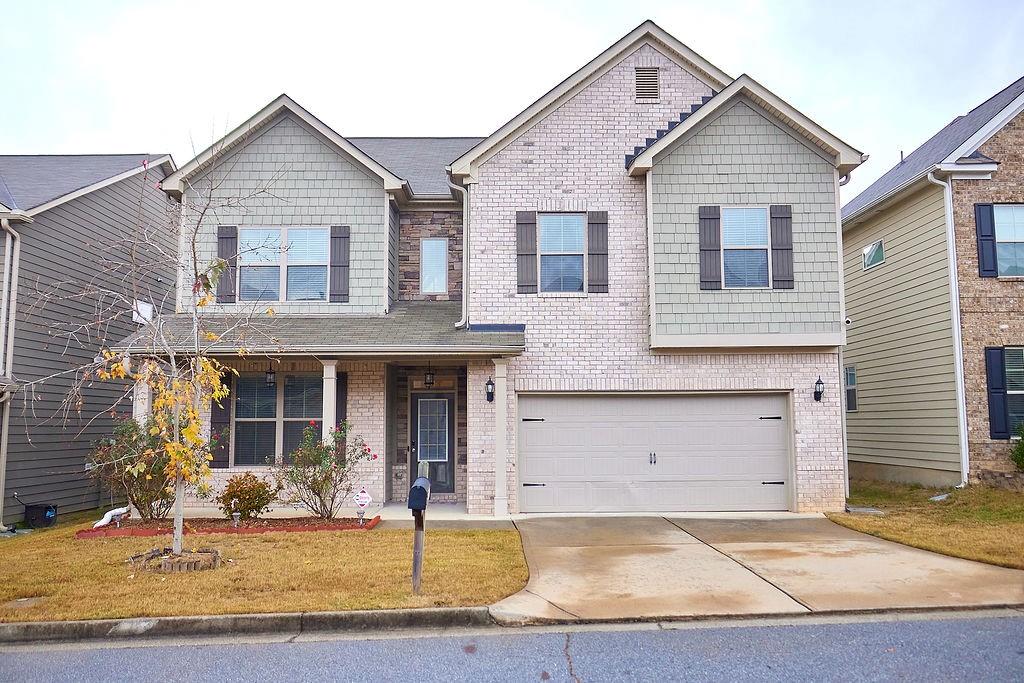 7687 Volion Drive Fairburn, GA 30213 - Photo 1 of 1 a front view of a house with garden