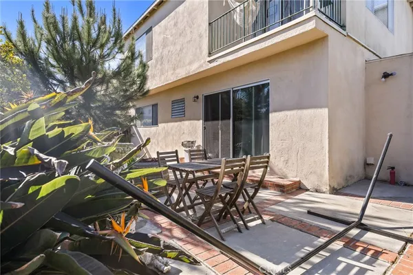 a view of a patio with table and chairs and potted plants