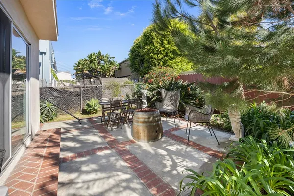 a view of a backyard of the house with green space