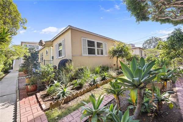 a view of a house with potted plants