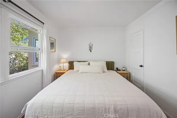 a bedroom with a bed and a window