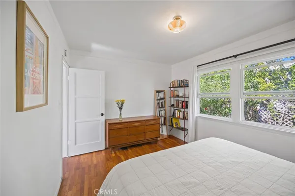 a bed room with a bed mirror and a window