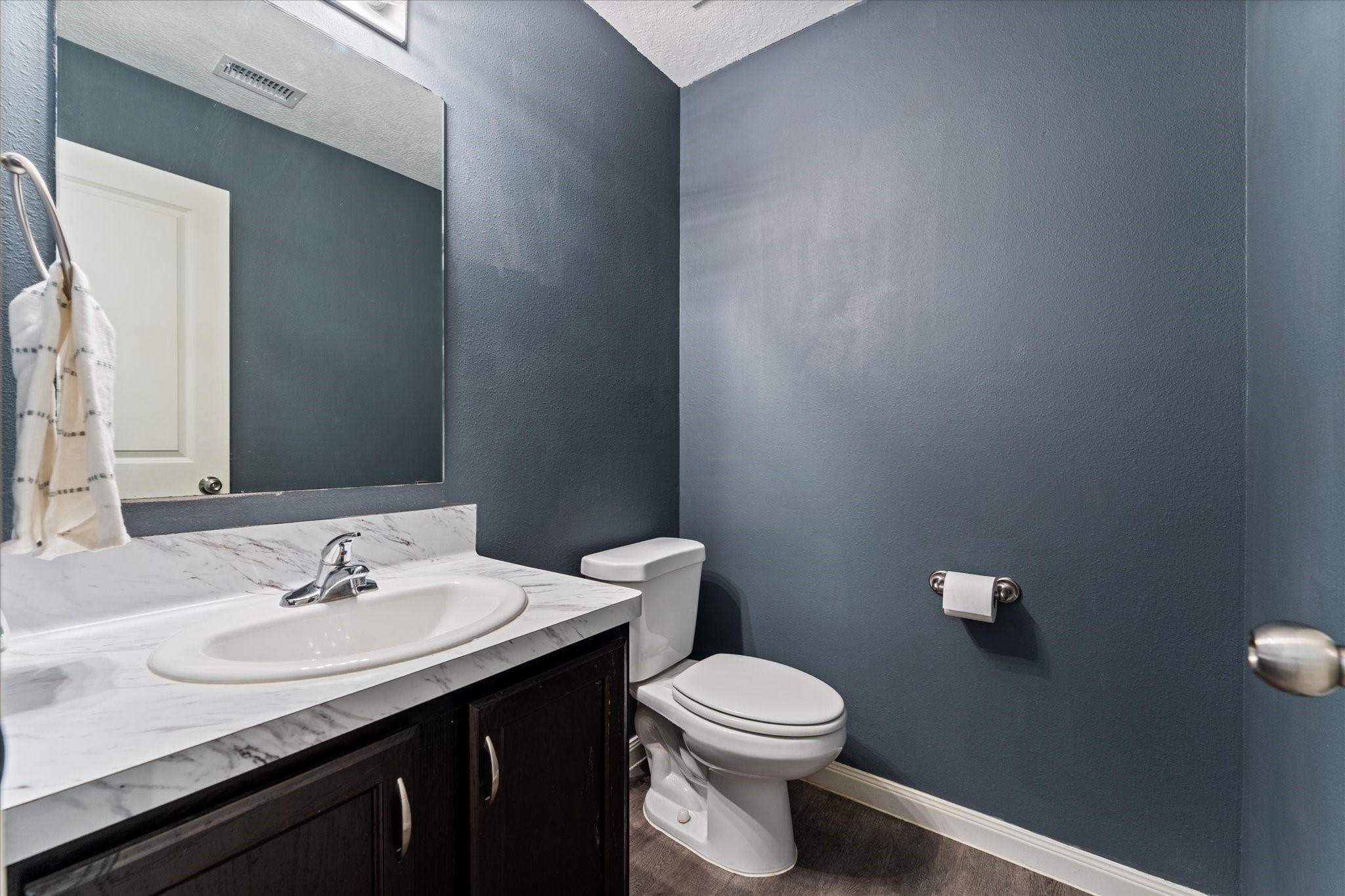 3998 Frontier Road Willis, TX 77378 - Photo 9 of 33 a bathroom with a granite countertop sink a toilet and a mirror