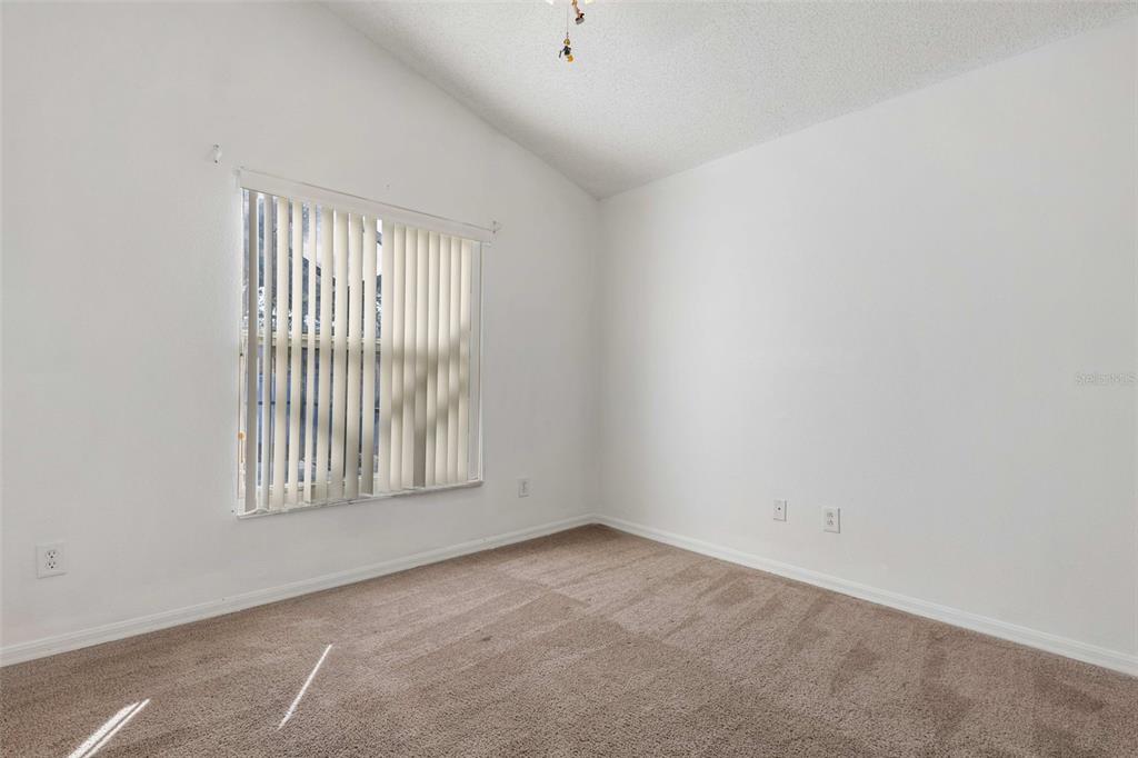 2627 Oneida Loop Kissimmee, FL 34747 - Photo 17 of 32 an empty room with windows