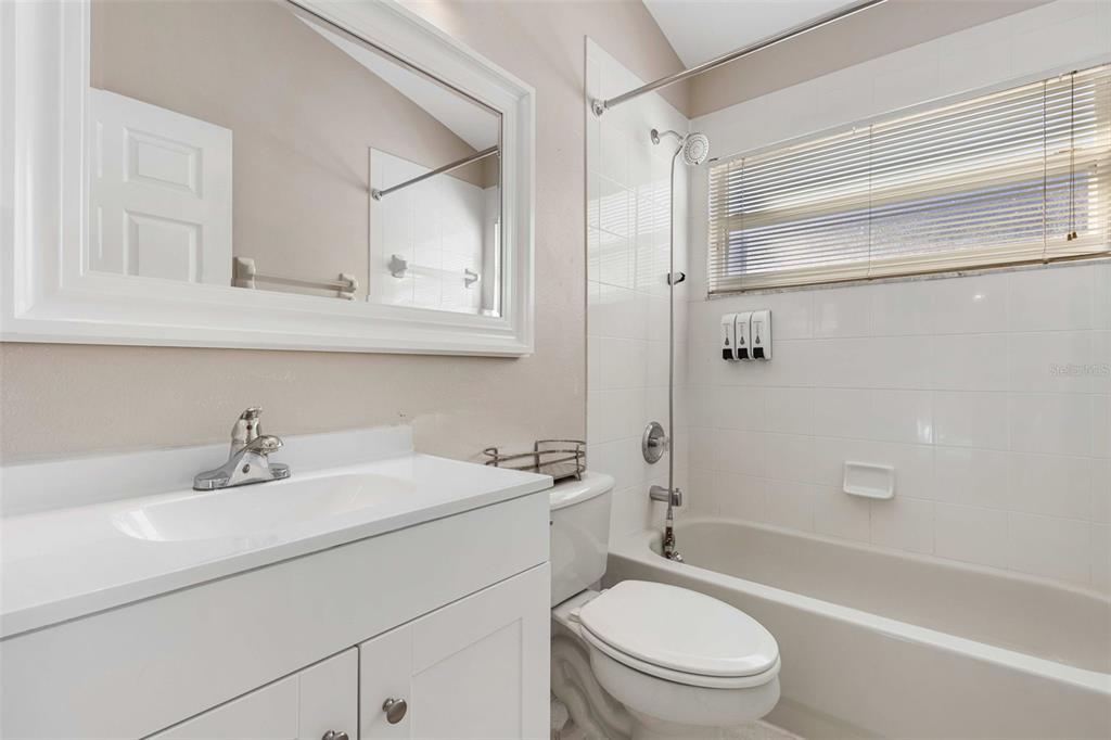2627 Oneida Loop Kissimmee, FL 34747 - Photo 25 of 32 a bathroom with a sink toilet vanity and bathtub