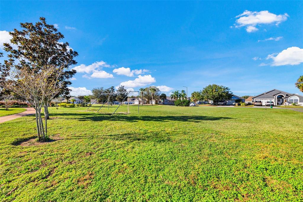 2627 Oneida Loop Kissimmee, FL 34747 - Photo 29 of 32 a view of a golf course with a lake
