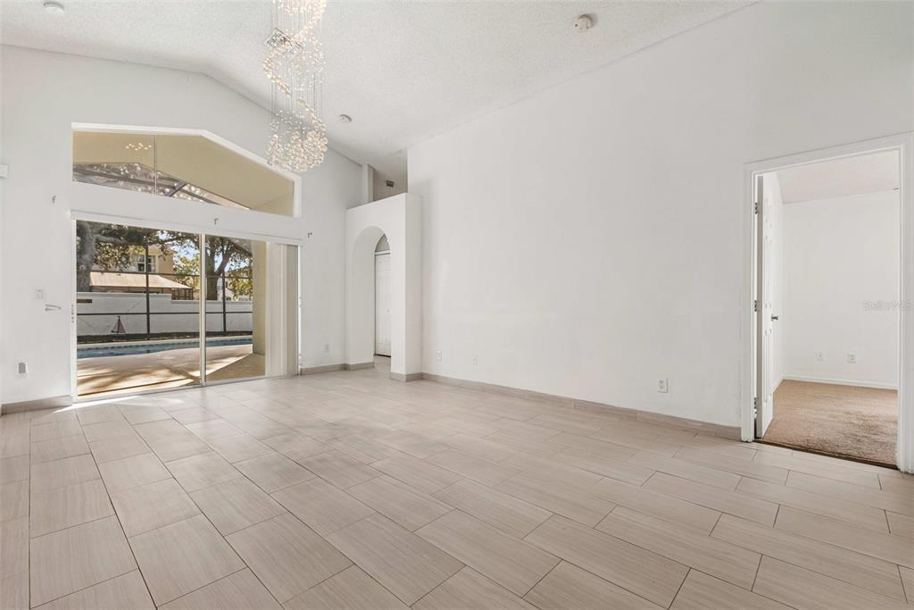 2627 Oneida Loop Kissimmee, FL 34747 - Photo 8 of 32 an empty room with sliding door