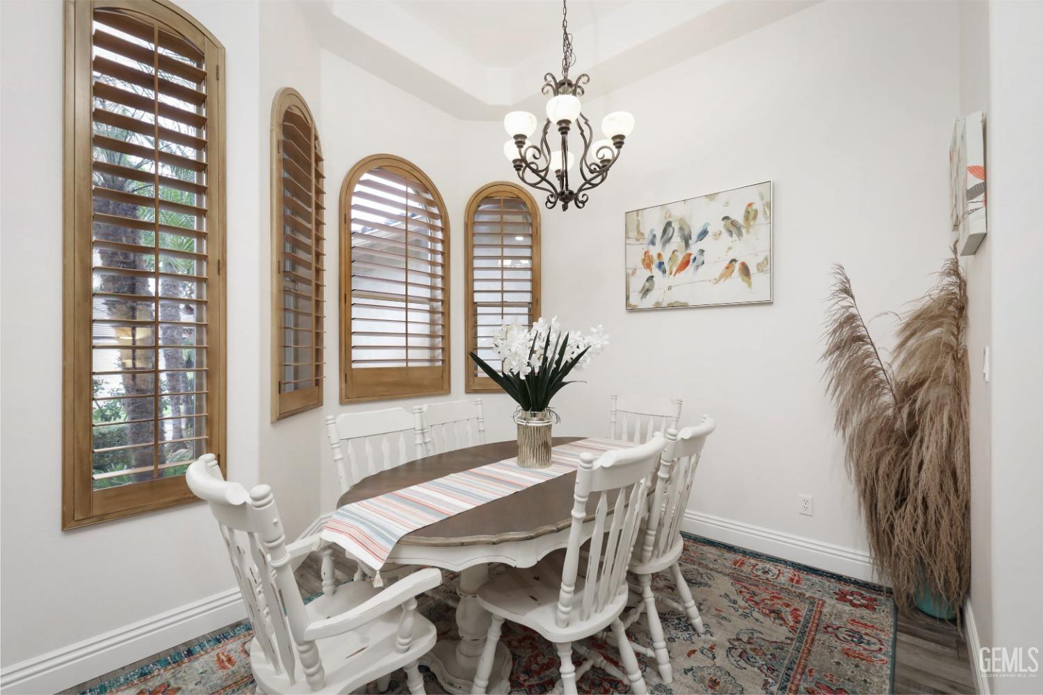 Undisclosed Address Bakersfield, CA 93312 - Photo 12 of 36 a view of a dining room with furniture and chandelier