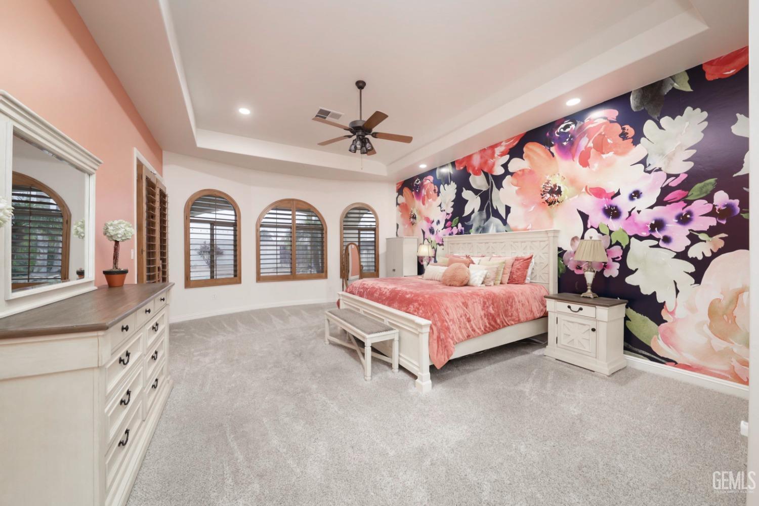 Undisclosed Address Bakersfield, CA 93312 - Photo 13 of 36 a spacious bedroom with a bed next to a window and a flat screen tv