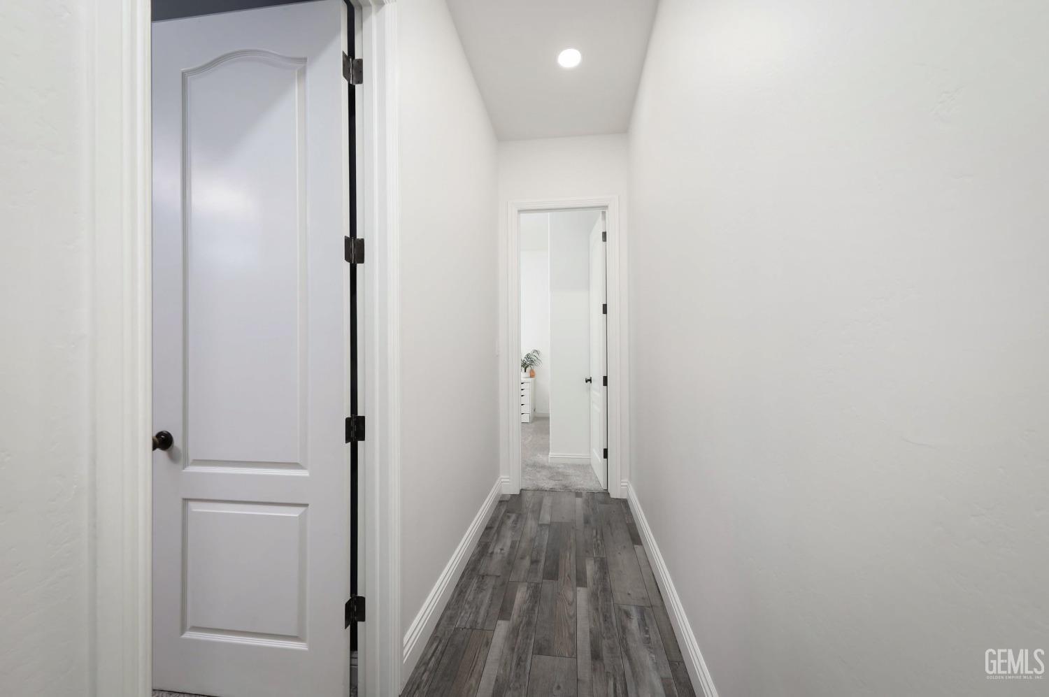 Undisclosed Address Bakersfield, CA 93312 - Photo 23 of 36 a view of a hallway with wooden floor