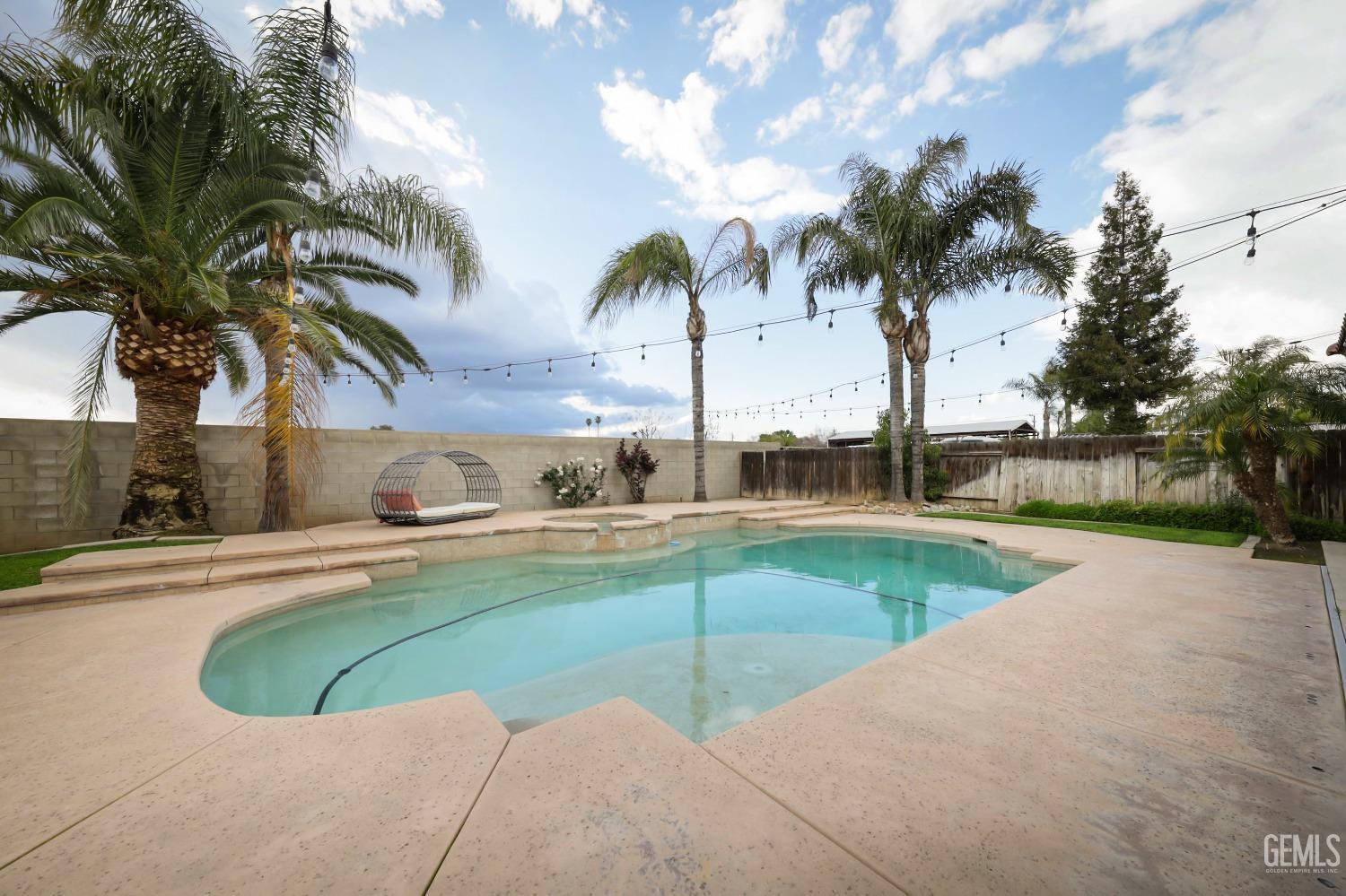 Undisclosed Address Bakersfield, CA 93312 - Photo 26 of 36 a view of swimming pool with a seating space and palm tree
