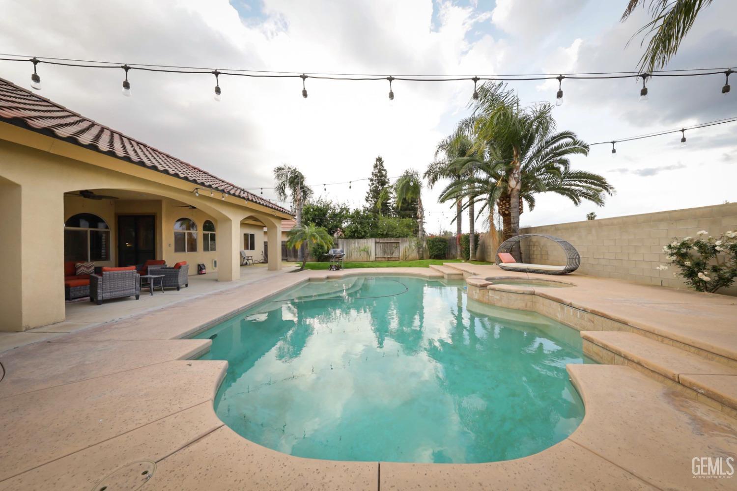 Undisclosed Address Bakersfield, CA 93312 - Photo 28 of 36 a view of a swimming pool with a lounge chairs