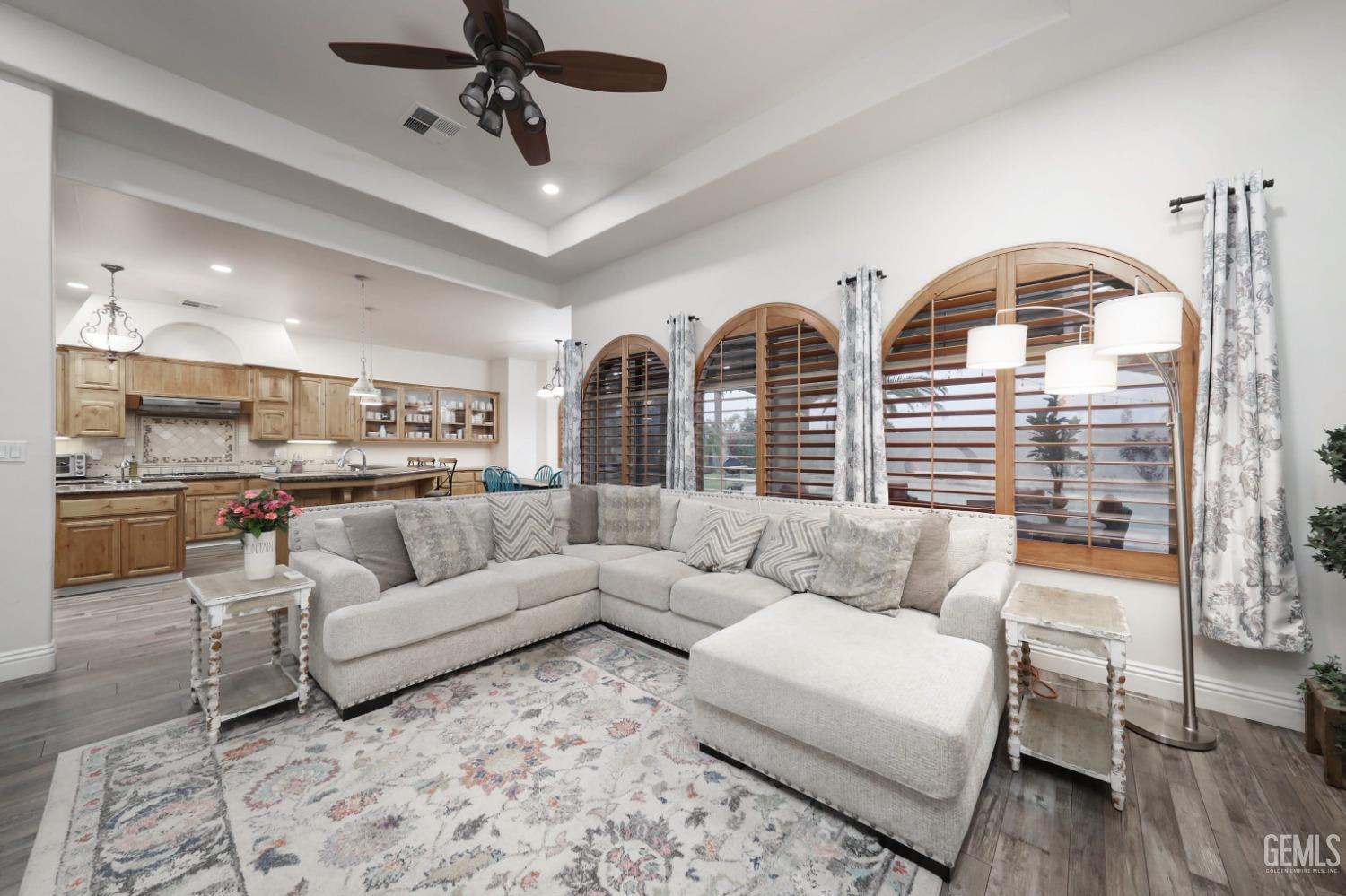 Undisclosed Address Bakersfield, CA 93312 - Photo 6 of 36 a living room with furniture kitchen view and a chandelier