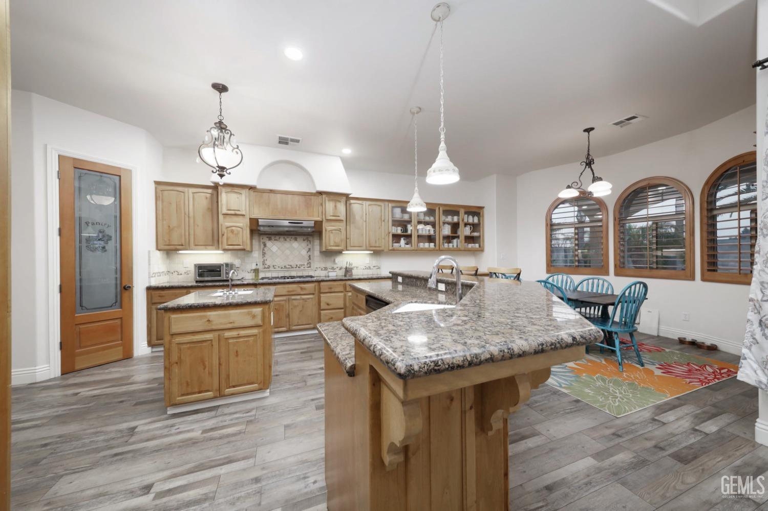 Undisclosed Address Bakersfield, CA 93312 - Photo 7 of 36 a kitchen with center island table and chairs in it