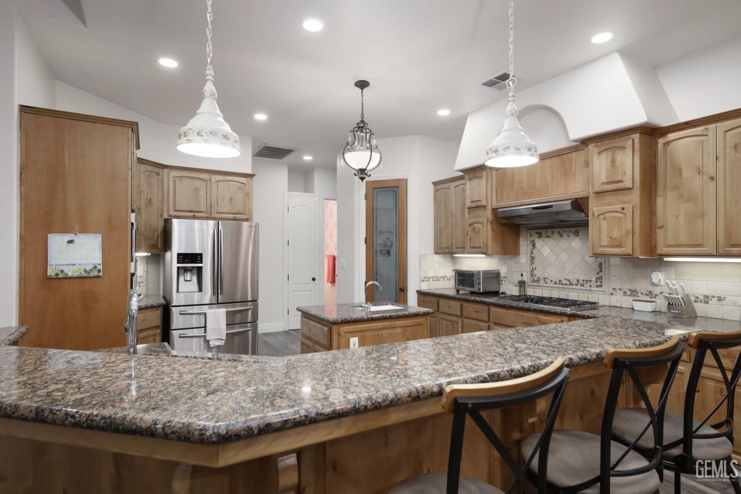Undisclosed Address Bakersfield, CA 93312 - Photo 8 of 36 a kitchen with stainless steel appliances granite countertop a sink a stove and a refrigerator