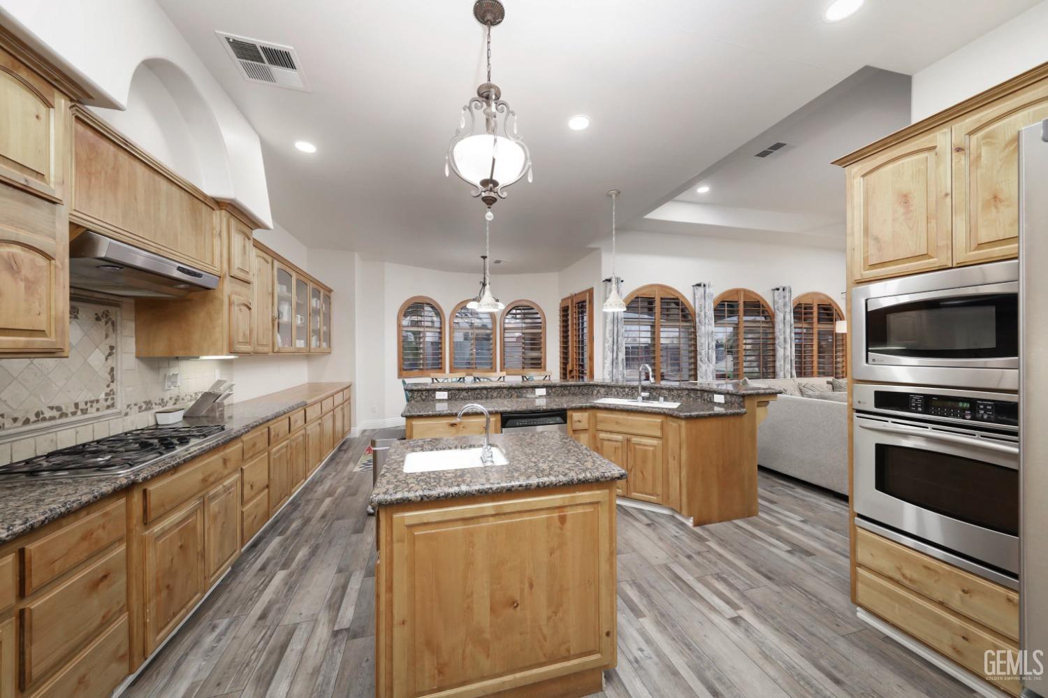 Undisclosed Address Bakersfield, CA 93312 - Photo 10 of 36 a large kitchen with stainless steel appliances granite countertop a stove and cabinets