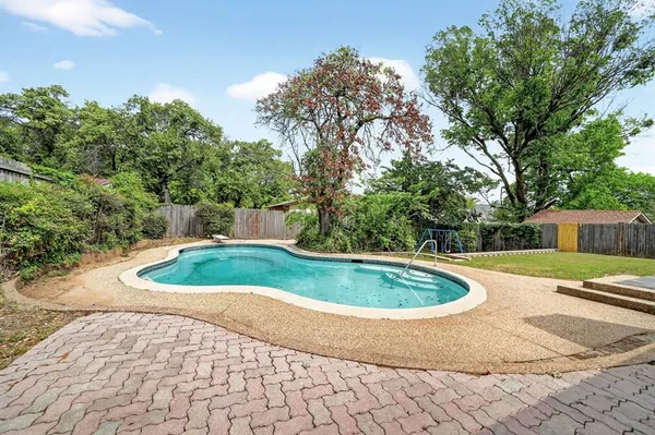 a view of a swimming pool with a yard