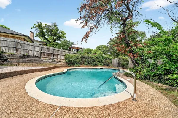 a view of a swimming pool with a yard