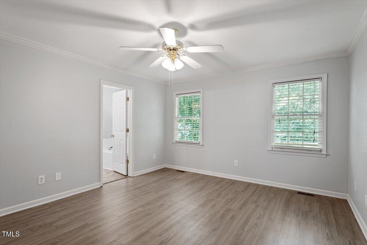 2474 Sumter Drive Garner, NC 27529 - Photo 13 of 27 a view of an empty room with wooden floor and a window