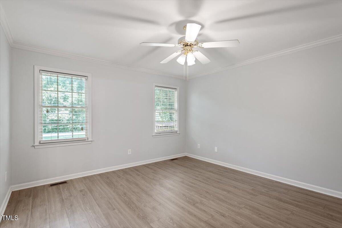 2474 Sumter Drive Garner, NC 27529 - Photo 14 of 27 a view of an empty room with wooden floor and a window