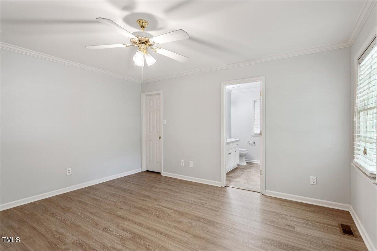 2474 Sumter Drive Garner, NC 27529 - Photo 15 of 27 wooden floor in an empty room with a window