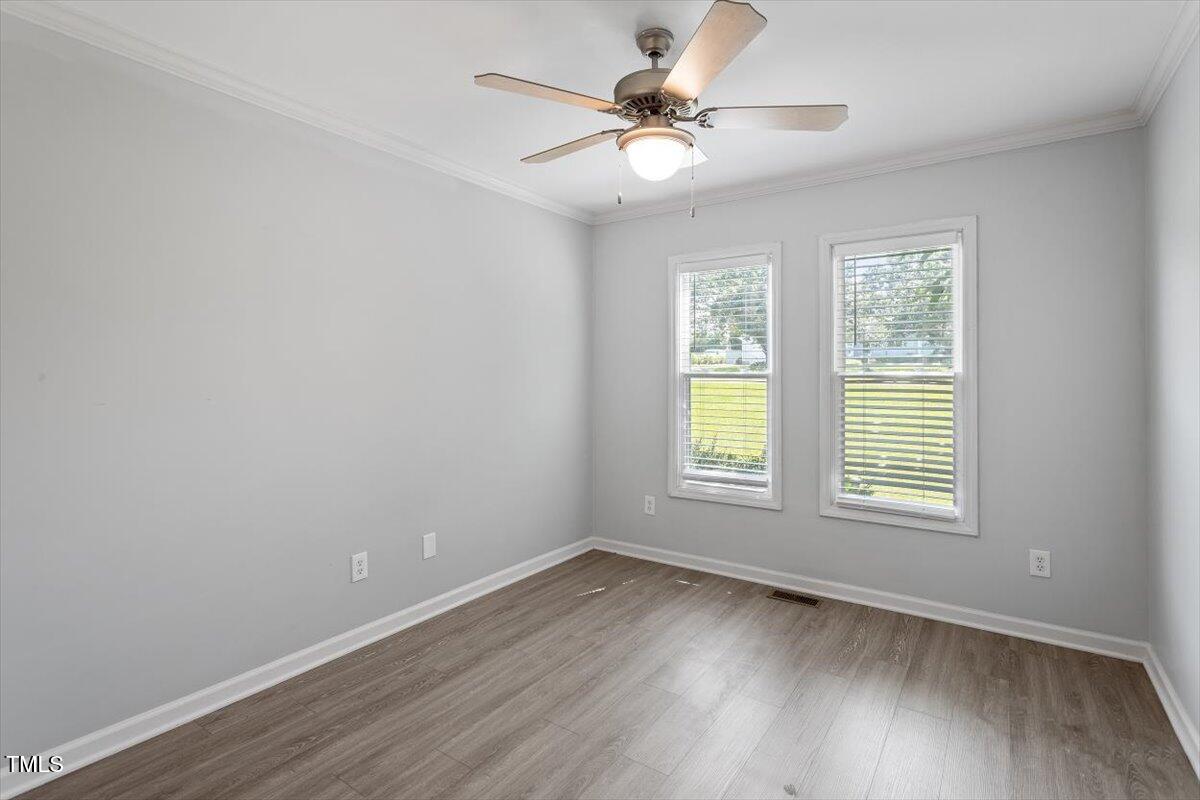 2474 Sumter Drive Garner, NC 27529 - Photo 18 of 27 wooden floor in an empty room with a window