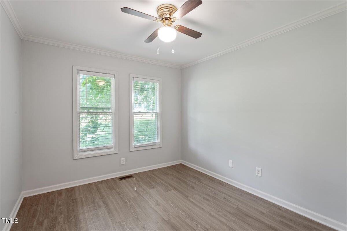 2474 Sumter Drive Garner, NC 27529 - Photo 21 of 27 wooden floor in an empty room with a window