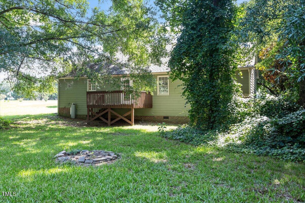 2474 Sumter Drive Garner, NC 27529 - Photo 23 of 27 a view of backyard with wooden fence and a large tree