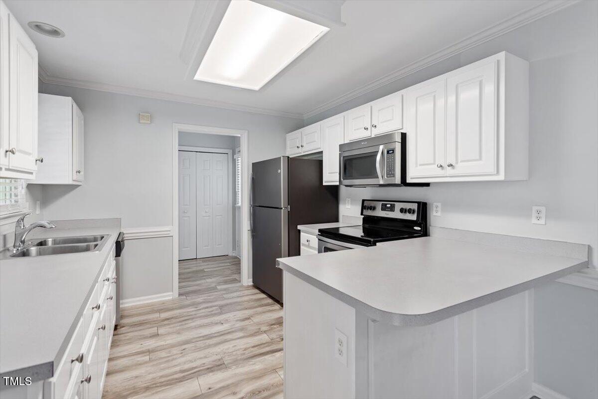2474 Sumter Drive Garner, NC 27529 - Photo 8 of 27 a kitchen with granite countertop a refrigerator stove and sink