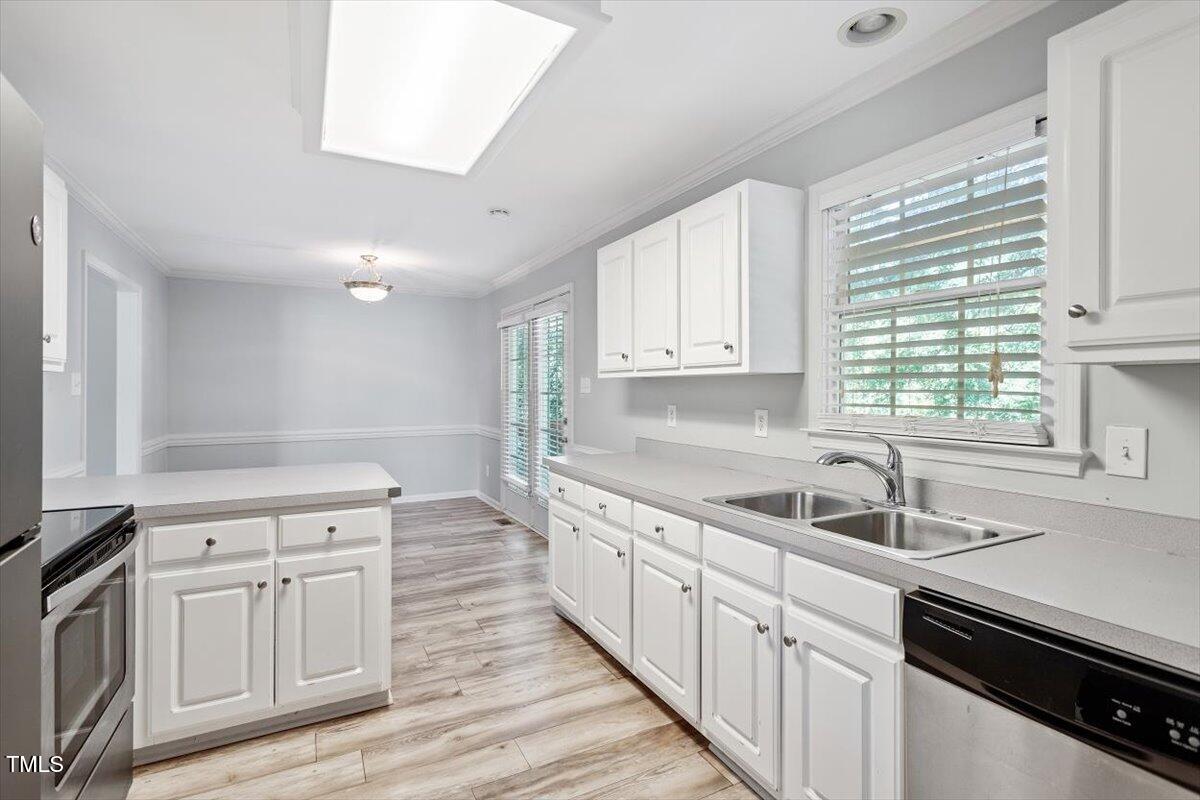 2474 Sumter Drive Garner, NC 27529 - Photo 10 of 27 a kitchen with white cabinets and sink
