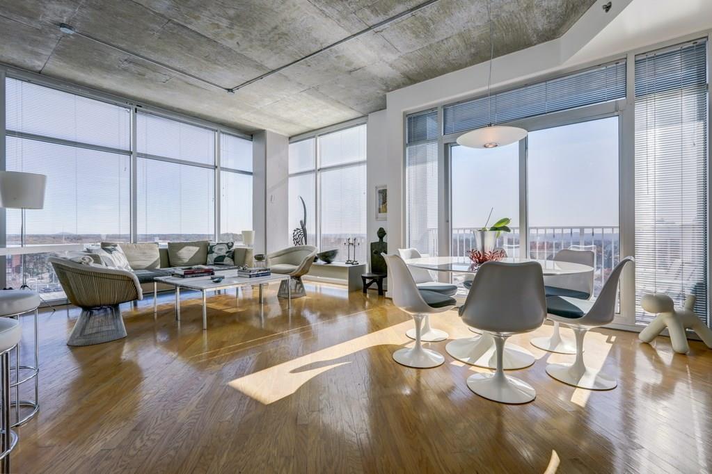 a view of a dining room with furniture a chandelier and wooden floor