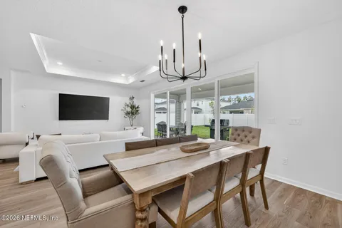 a living room with lots of furniture and a wooden floor