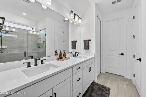 a bathroom with a glass shower door