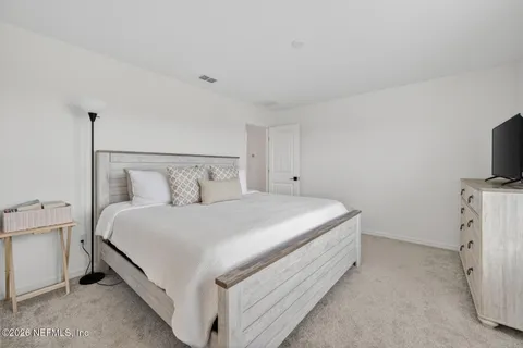 a bed room with a bed and a night stand