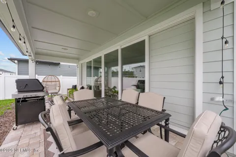 a view of a patio with couches table and chairs and potted plants