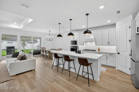a kitchen with stainless steel appliances a sink a stove a microwave and cabinets