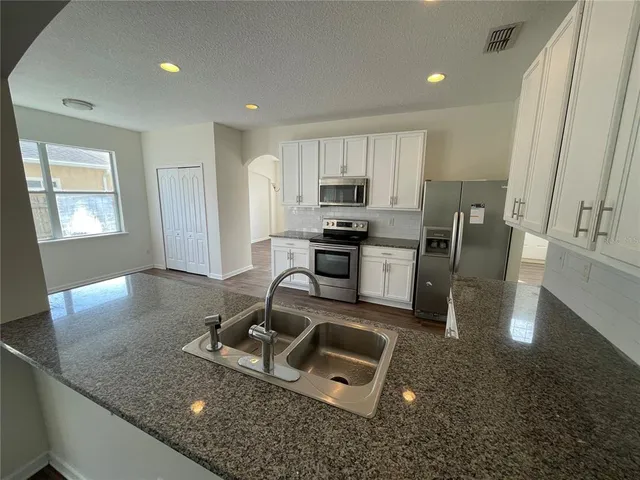 an empty room with a empty space and windows