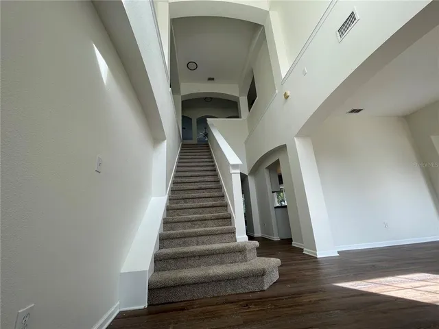 a view of entryway and hall with wooden floor