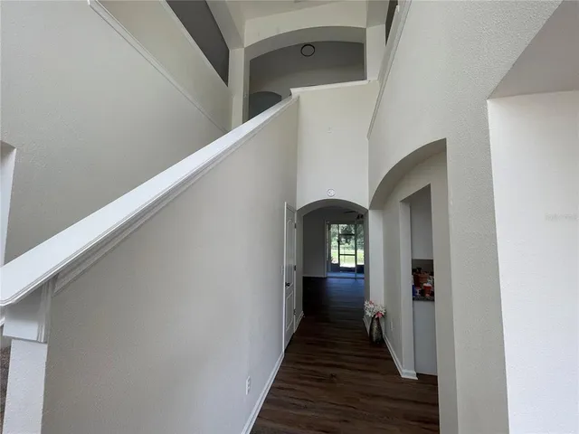 a view of a hallway view with wooden floor and staircase