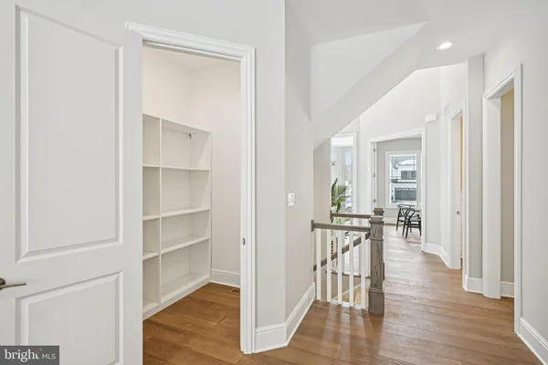 a view of a hallway with wooden floor windows and entryway