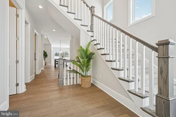 a view of entryway with wooden floor and stairs
