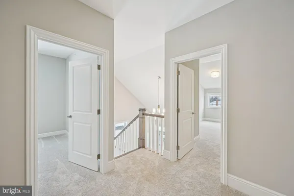 an empty room with windows and ceiling fan