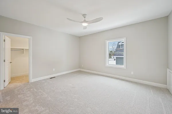 a bathroom with a granite countertop sink two mirror and shower