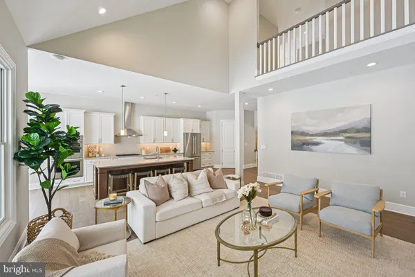 a living room with furniture potted plant and a table