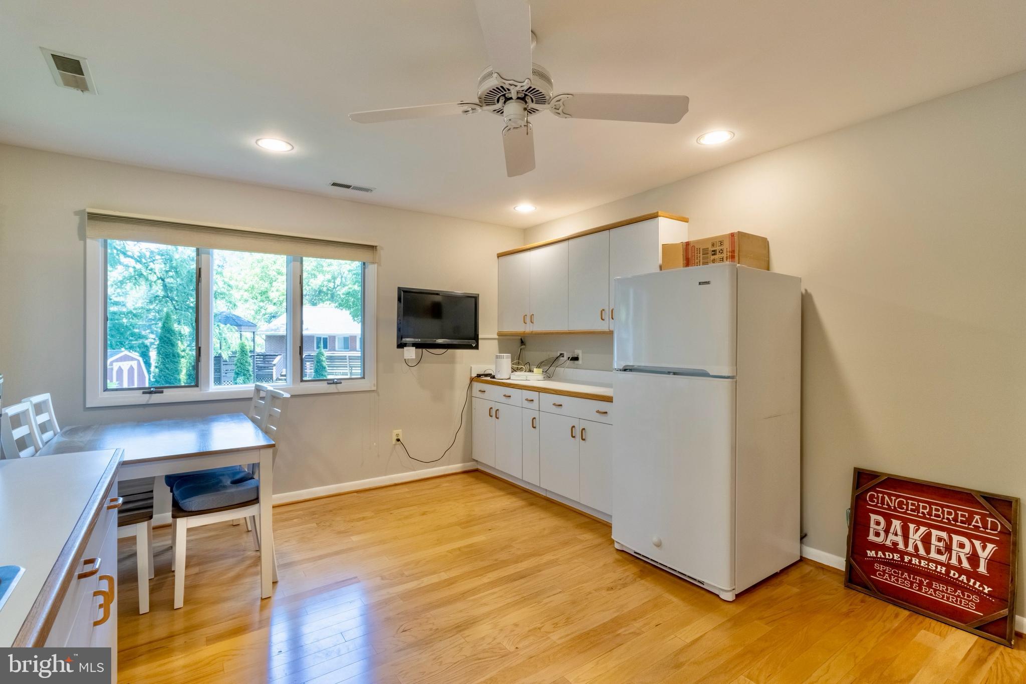 7613 Hamlet Street Springfield, VA 22151 - Photo 14 of 18 a kitchen with furniture a refrigerator and wooden cabinets