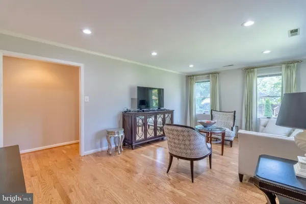 a living room with furniture a window and a flat screen tv