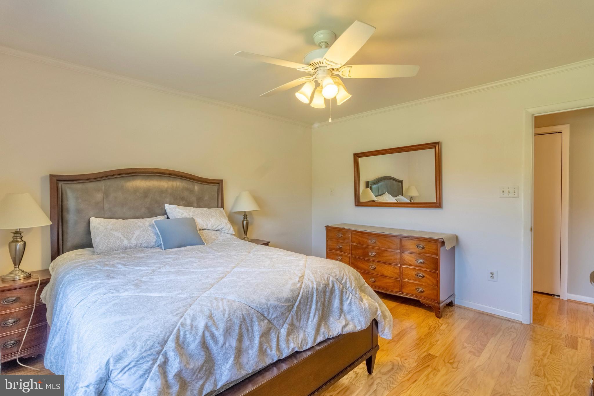 7613 Hamlet Street Springfield, VA 22151 - Photo 8 of 18 a bedroom with a bed and a chandelier