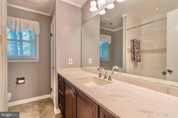 a bathroom with a sink double vanity and a mirror