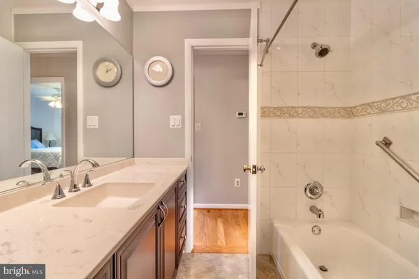 a bathroom with a tub sink and mirror